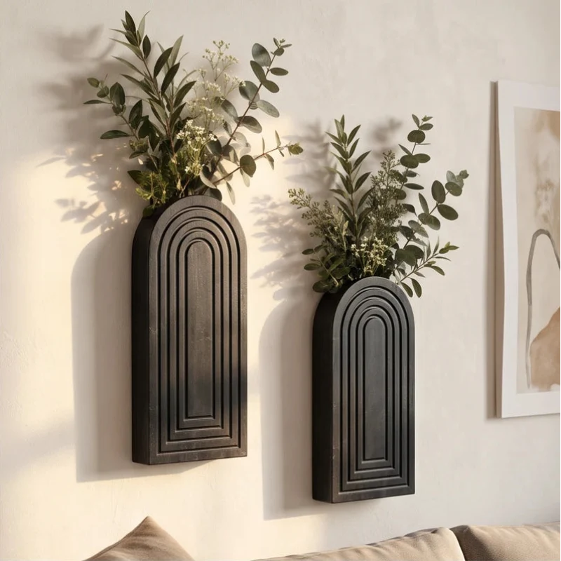 Black wood vase styled in a warm home setting