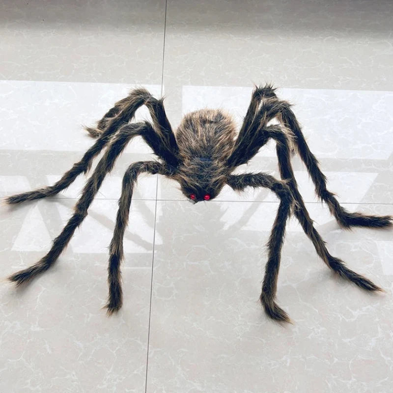 A large realistic fake spider toy with long dark hairy legs and small red eyes, placed on a light gray tiled floor.