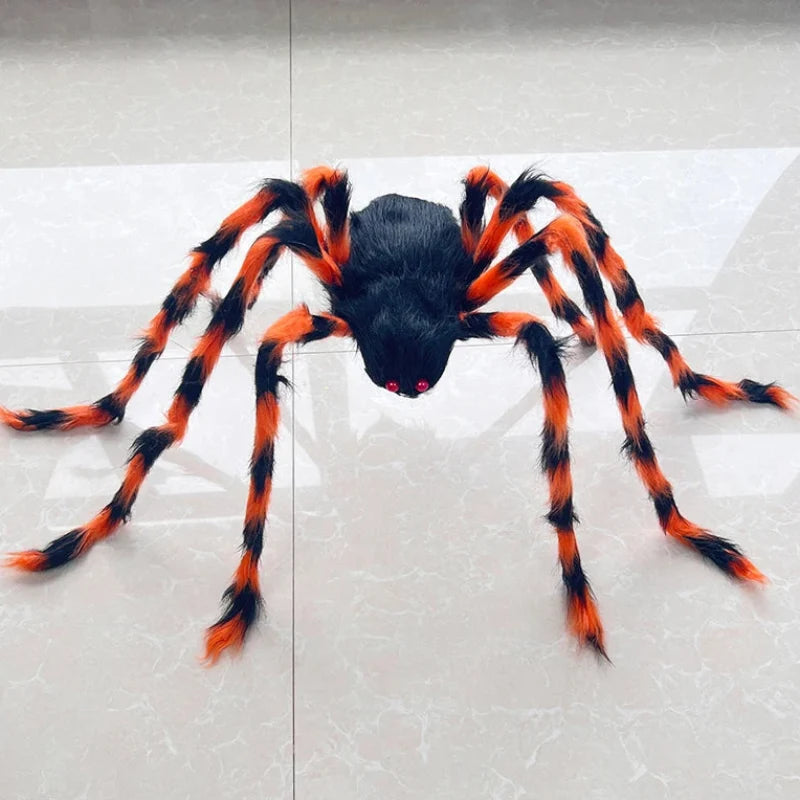 A large Halloween toy spider with a black body and bright orange and black striped legs, positioned on a light gray tiled floor.