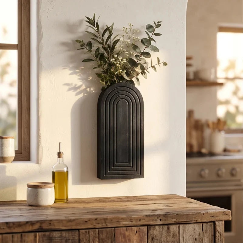 Black wood vase styled in a warm home setting